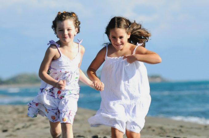 kids running on the beach in summer