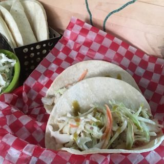 Delicious and easy Tex-Mex Fish Tacos - a hint of sweet and spicy Texas flavor packed into a corn tortilla with coleslaw and serrano sauce.